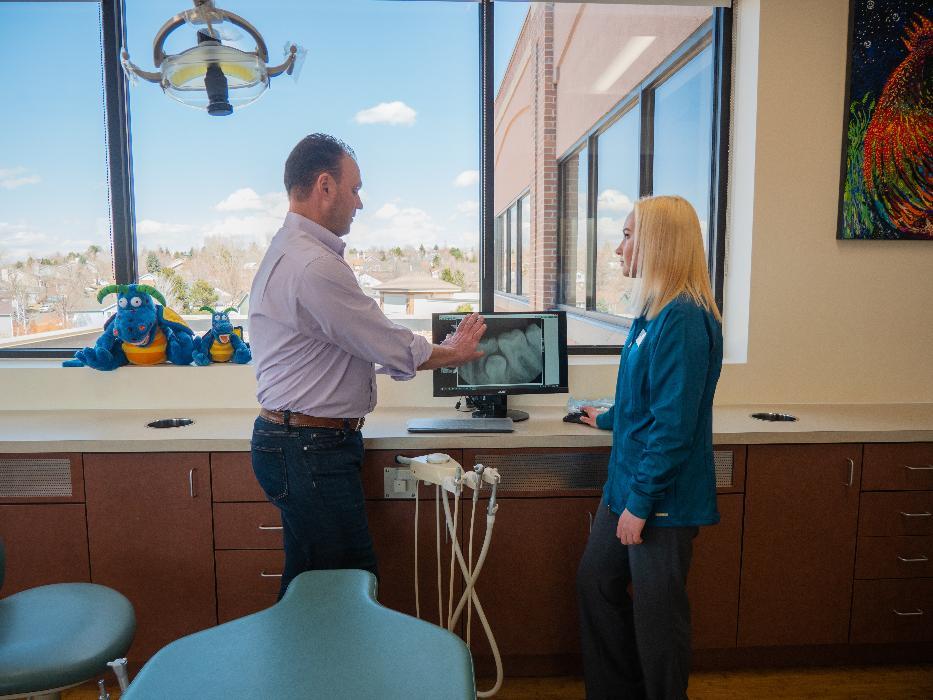 Dr. Sierk looking at X-Rays | tooth extraction for children in Highlands Ranch